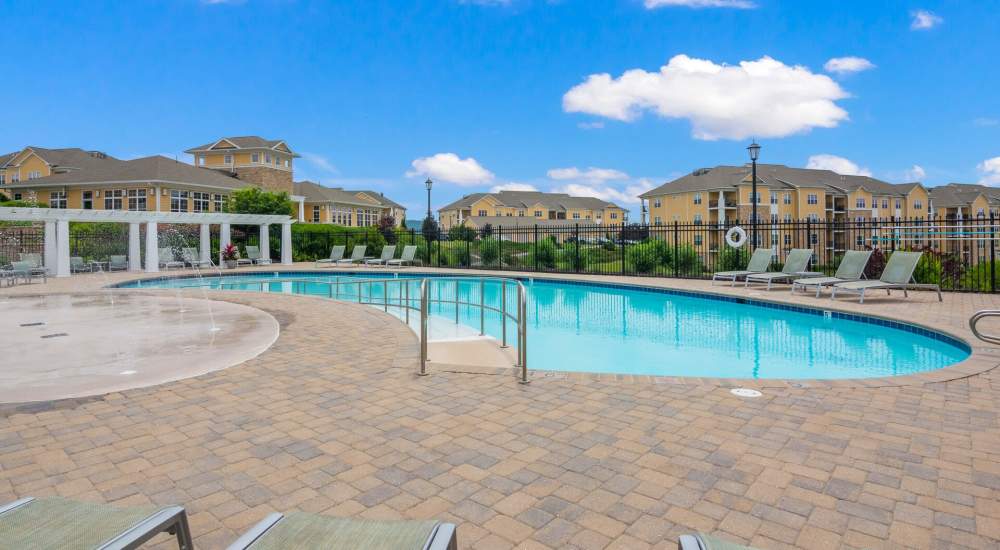 Community pool with lounge chairs at The Apartments at Goose Creek in Fishersville, Virginia
