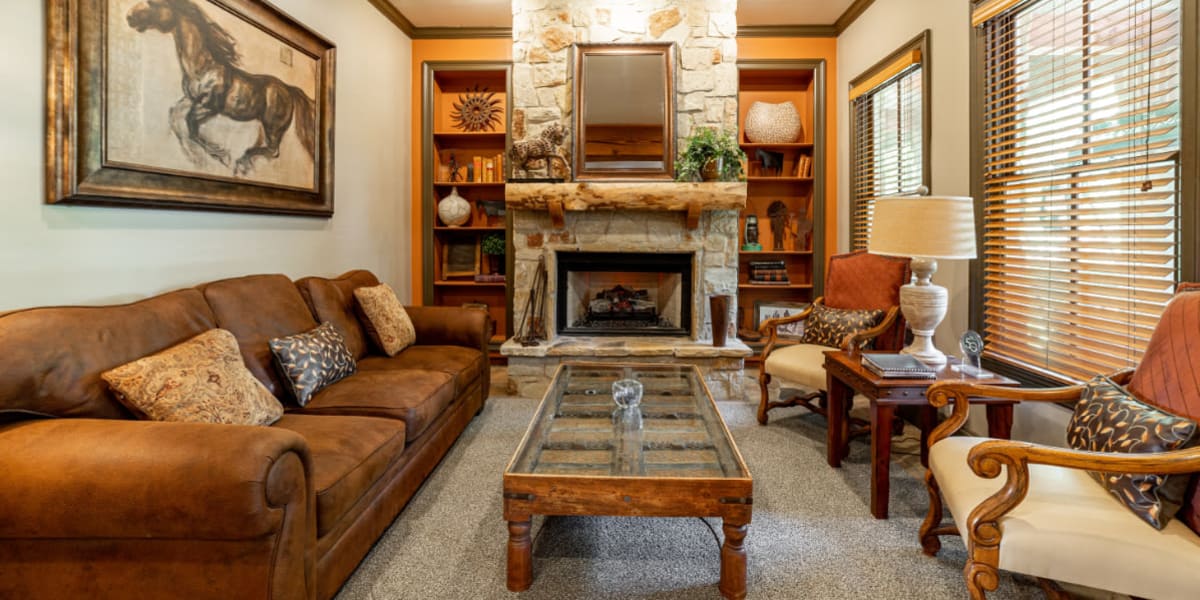 Pool table, seating area, and kitchen in rustic clubhouse at Marquis at Bellaire Ranch in Fort Worth, Texas