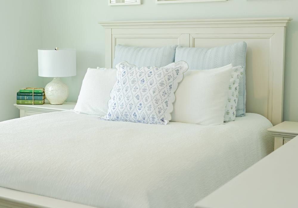 Bright bedroom with white bedsheet at Anchor Apartments in Freeport, Florida