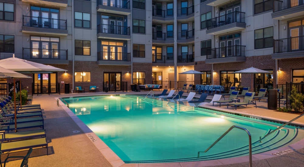 Resort-style swimming pool with lounge chairs at Siena Suwanee Town Center in Suwanee, Georgia