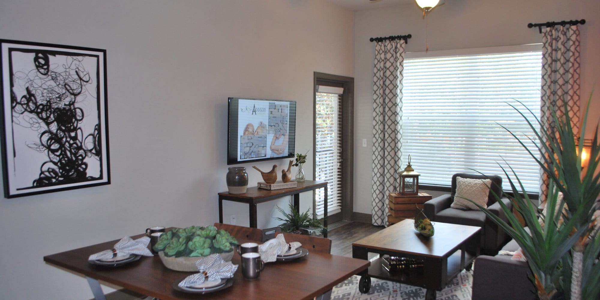 model unit with living room furnishings at Addison at Tampa Oaks in Temple Terrace, Florida