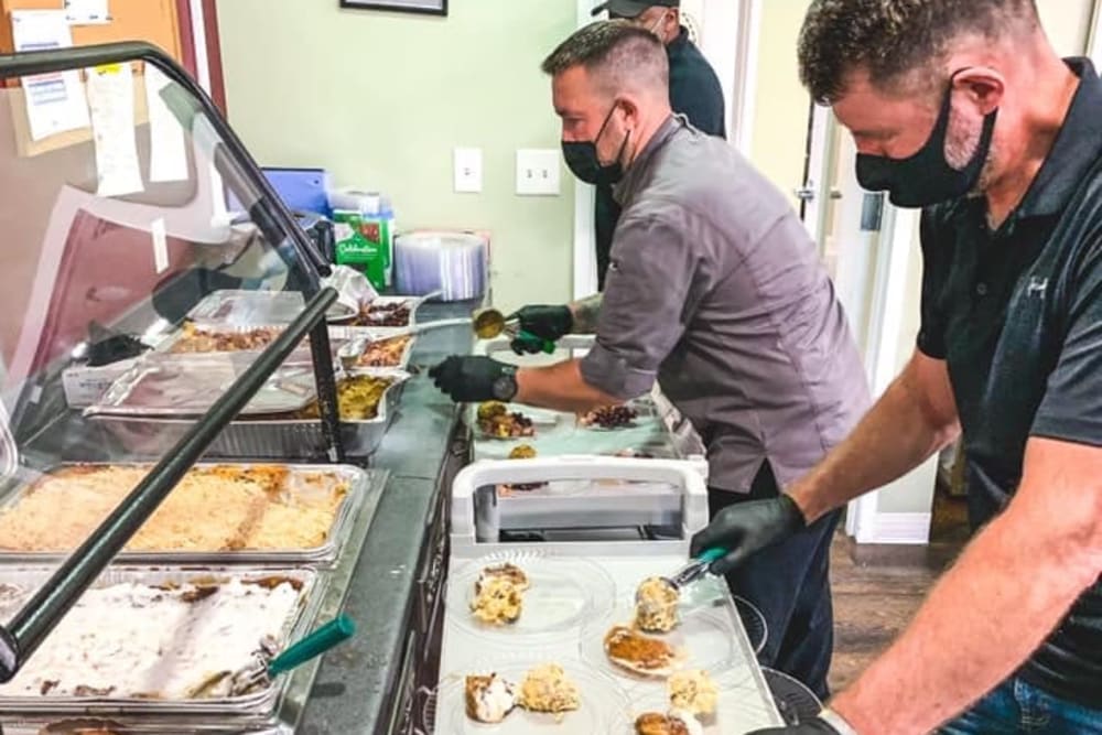 Staff serving nutritious meals to residents at Carolina Gardens at Conway in Conway, South Carolina