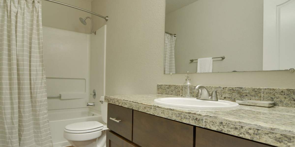 Luxury bathroom with fashionable counter tops and cabinets at Carriage House Apartments in Vancouver, Washington
