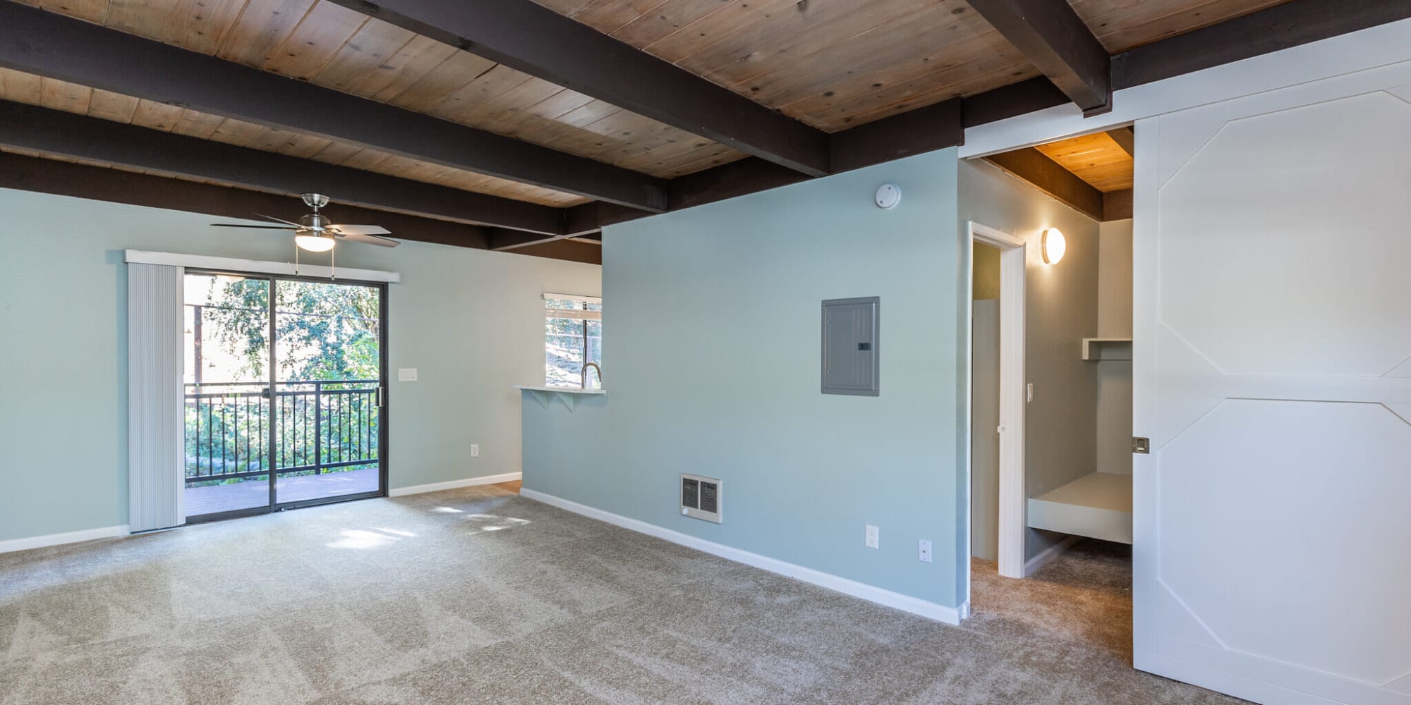 Living space with carpeted floors and beamed ceilings at  South Knoll in Mill Valley, California