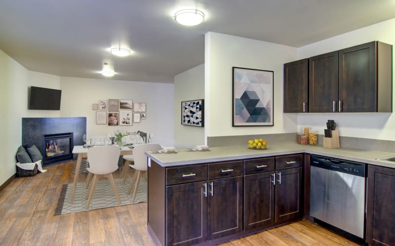 Spacious and bright kitchen and living room with a fireplace at The Addison Apartments in Vancouver, Washington
