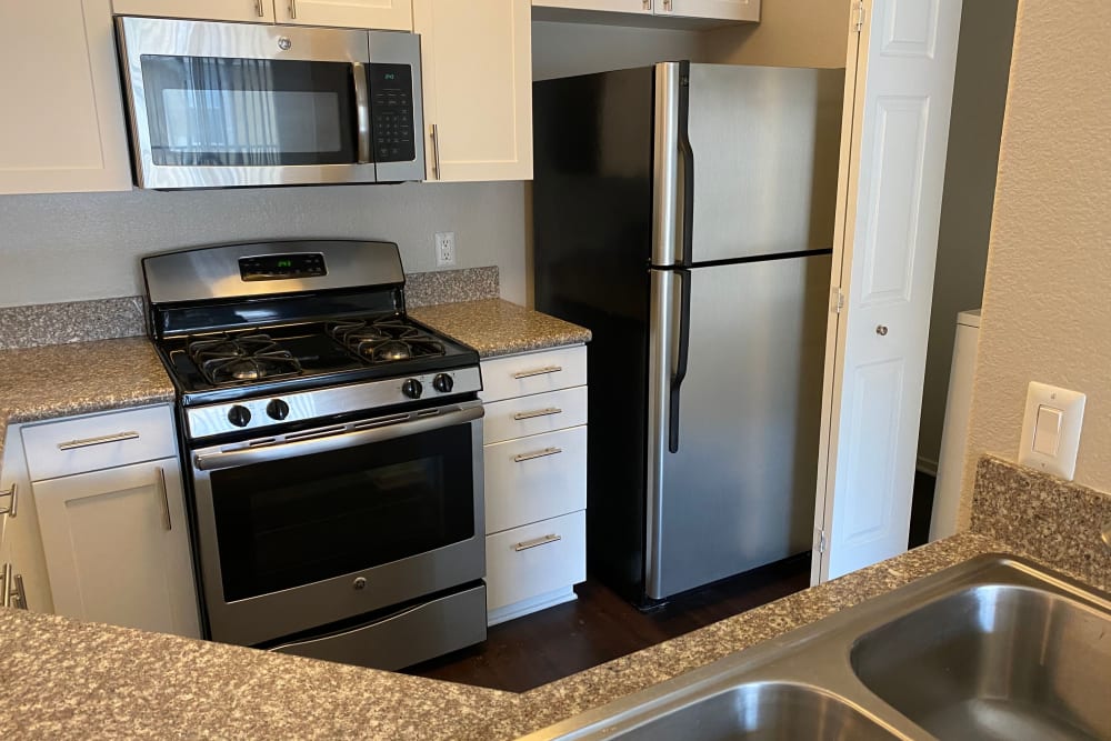 Modern kitchen with granite countertops in a model home at Avery at Moorpark in Moorpark, California