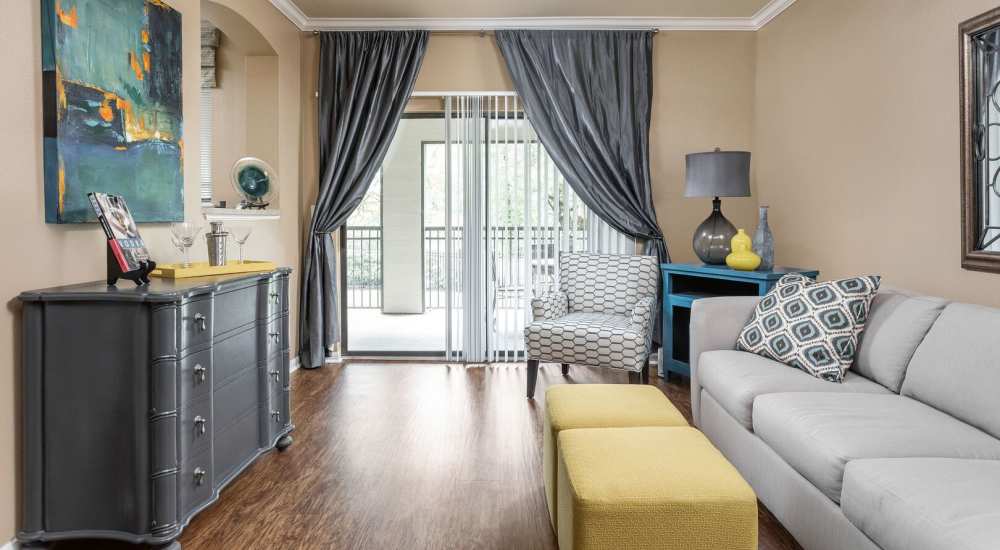 Bright living room with couch, coffee table and large windows at Stonebridge at the Ranch Apartments in Little Rock, Arkansas