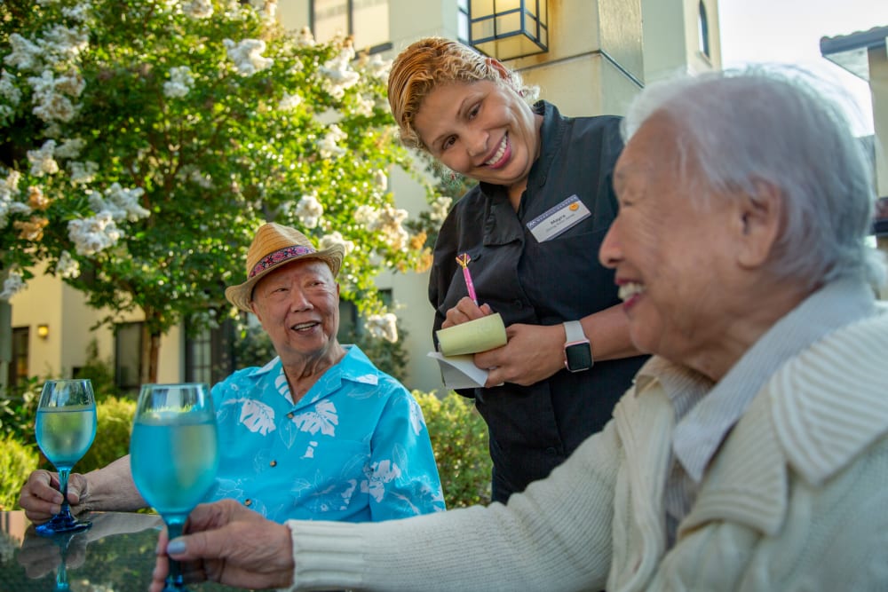 Two residents ordering food on the outdoor patio at Merrill Gardens at Lafayette in Lafayette, California. 