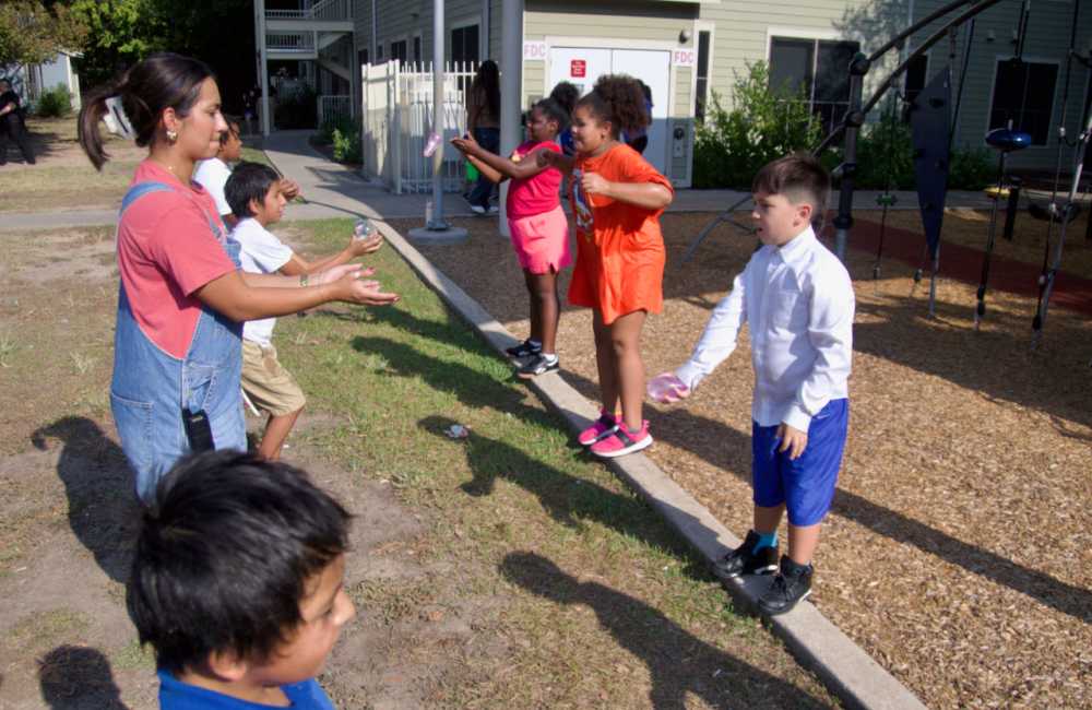 Playing with water balloons at M Station in Austin, Texas