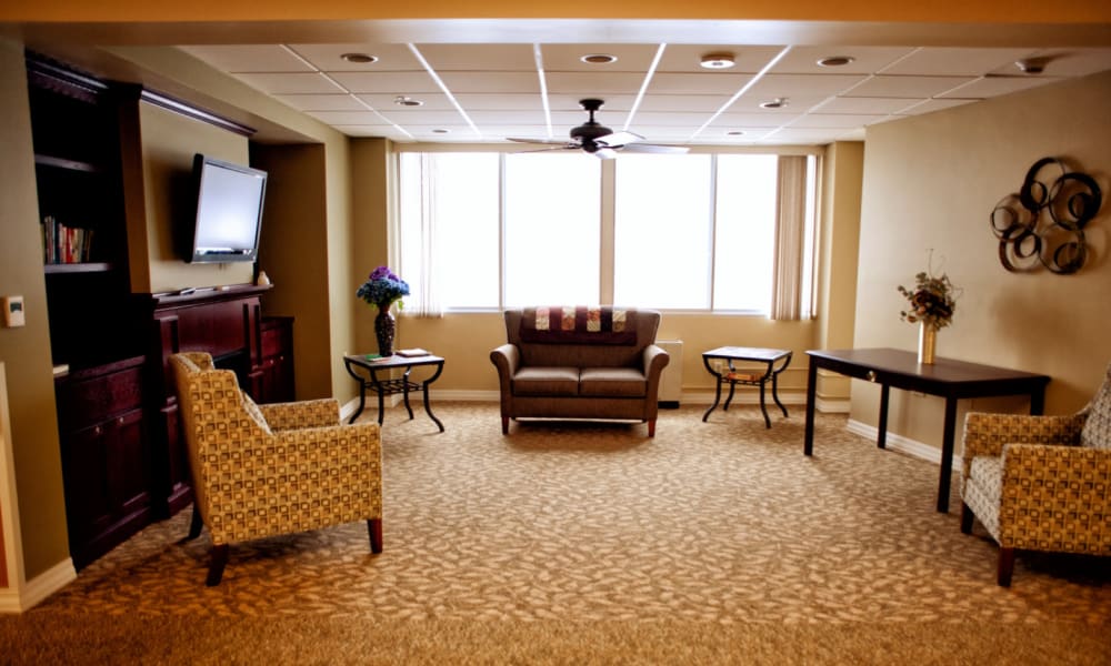 Common room with television and fireplace for residents at Edgerton Care Center in Edgerton, Wisconsin