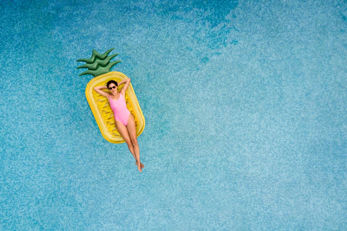 A resident on pineapple floatie in pool at Playa Pacifica, Playa Del Rey, California