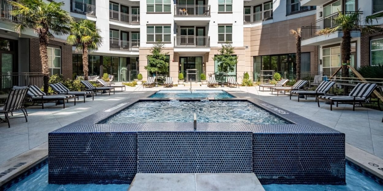 Resort-style pool and hot tub at Luxia Swiss Avenue, Dallas, Texas