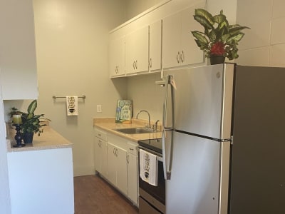 Model kitchen with wood flooring at Pennsylvania Apartments in Fremont, California