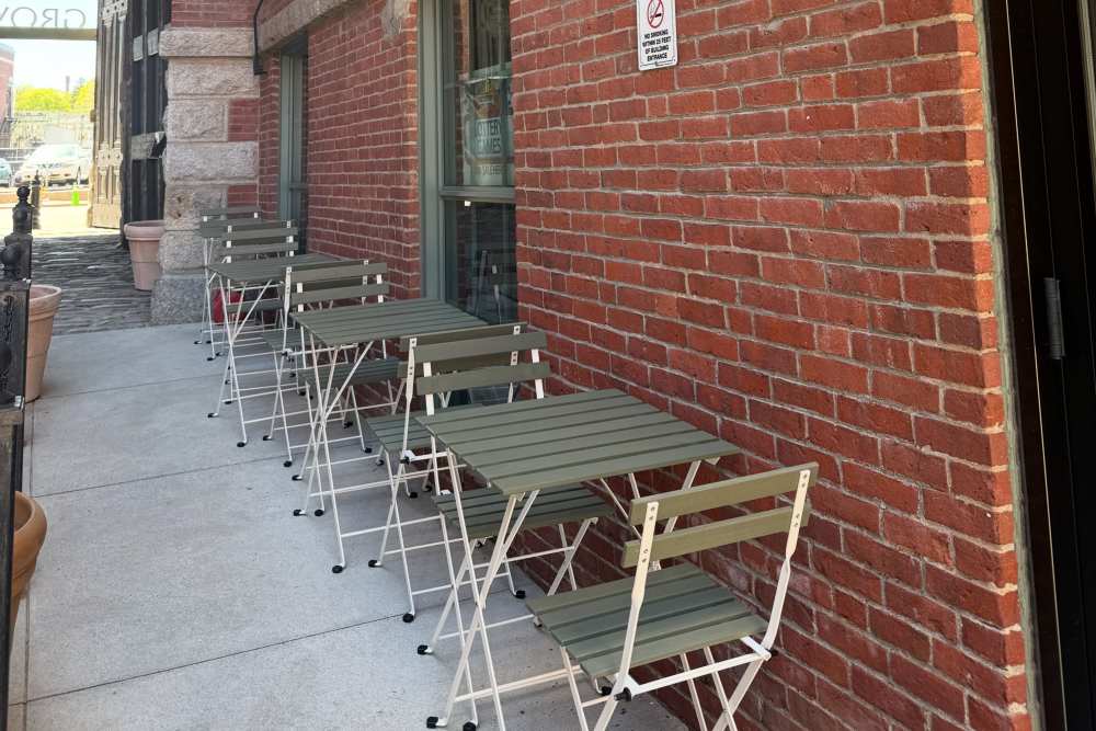 Outdoor seating along brick wall at Grove Village Lofts in Worcester, Massachusetts