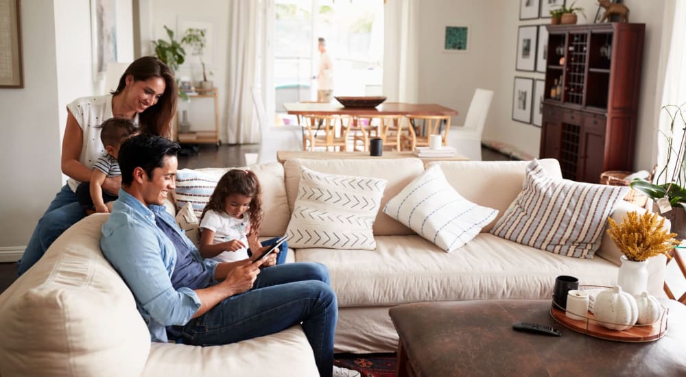 A family enjoys quality time in their townhome at Kennedy Highlands in Mc Kees Rocks, Pennsylvania