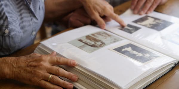 Resident looking through a photo album at Holton Manor in Elkhorn, Wisconsin