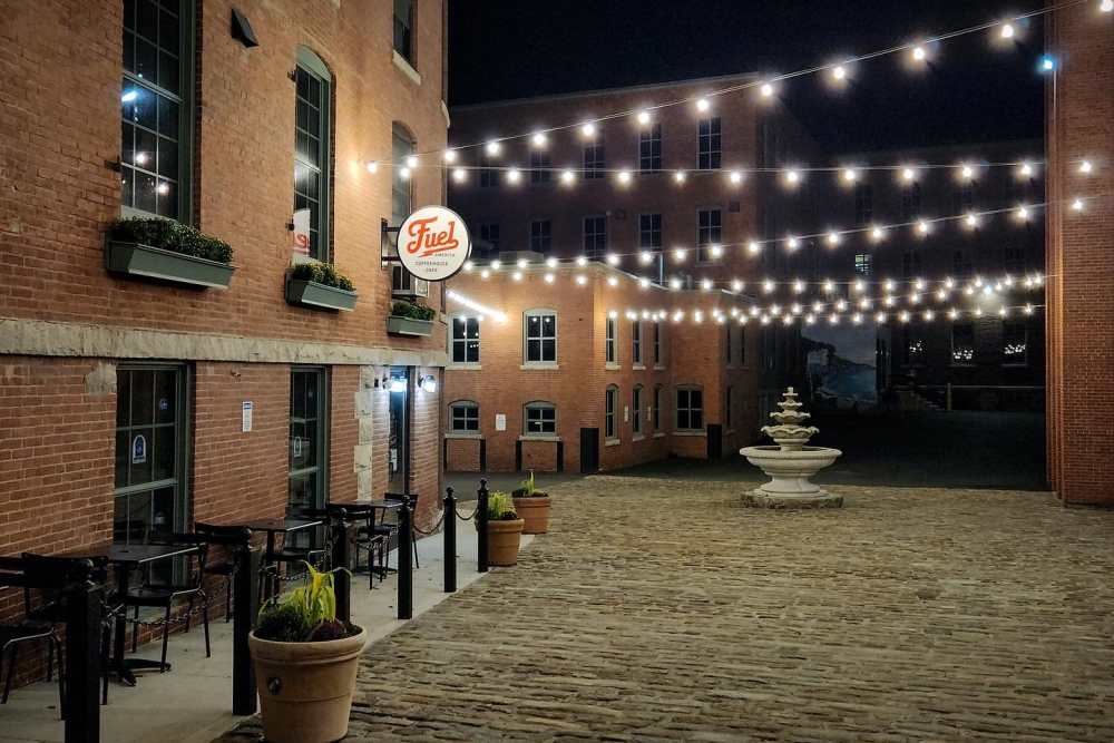 String-lit courtyard at night at Grove Village Lofts in Worcester, Massachusetts