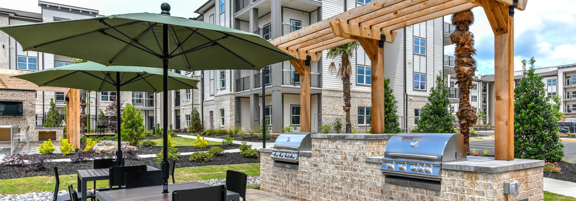 Gas grills and outdoor dining tables at Somerset in McDonough, Georgia