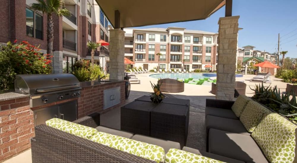 Covered Outdoor Kitchen with Dining Area & TV at Imperial Lofts in Sugar Land, Texas