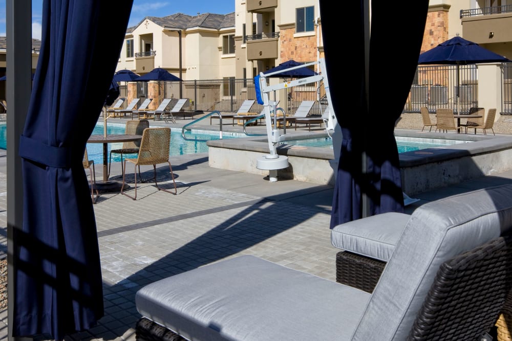 Covered lounge area by the pool at Olympus Alameda in Albuquerque, New Mexico