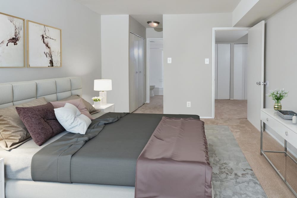 Spacious bedroom with ensuite bathroom and large closet at Landmark Glenmont Station in Silver Spring, Maryland