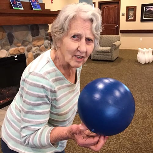 Resident holding a balloon at Oxford Glen Memory Care at Owasso in Owasso, Oklahoma