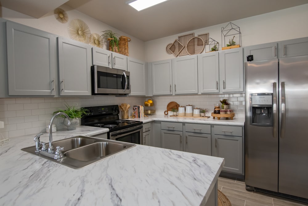 Modern kitchen with stainless-steel appliances in a model home at 24Hundred Apartments in Oklahoma City, Oklahoma