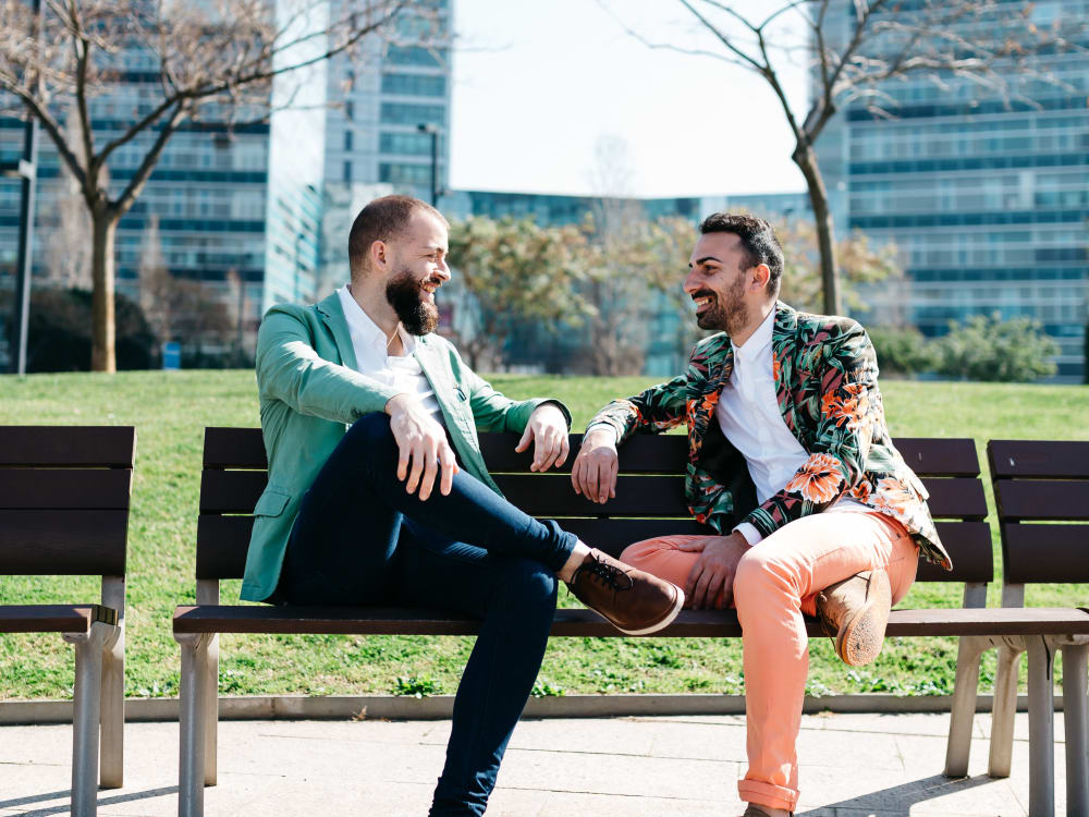 Resident friends chatting on a bench at a park near Sofi at Cedar Mill in Portland, Oregon