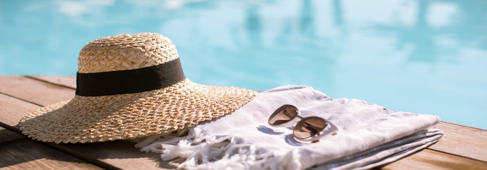 Hat and towel sitting out next to the refreshing pool at Mark at West Midtown in Atlanta, Georgia