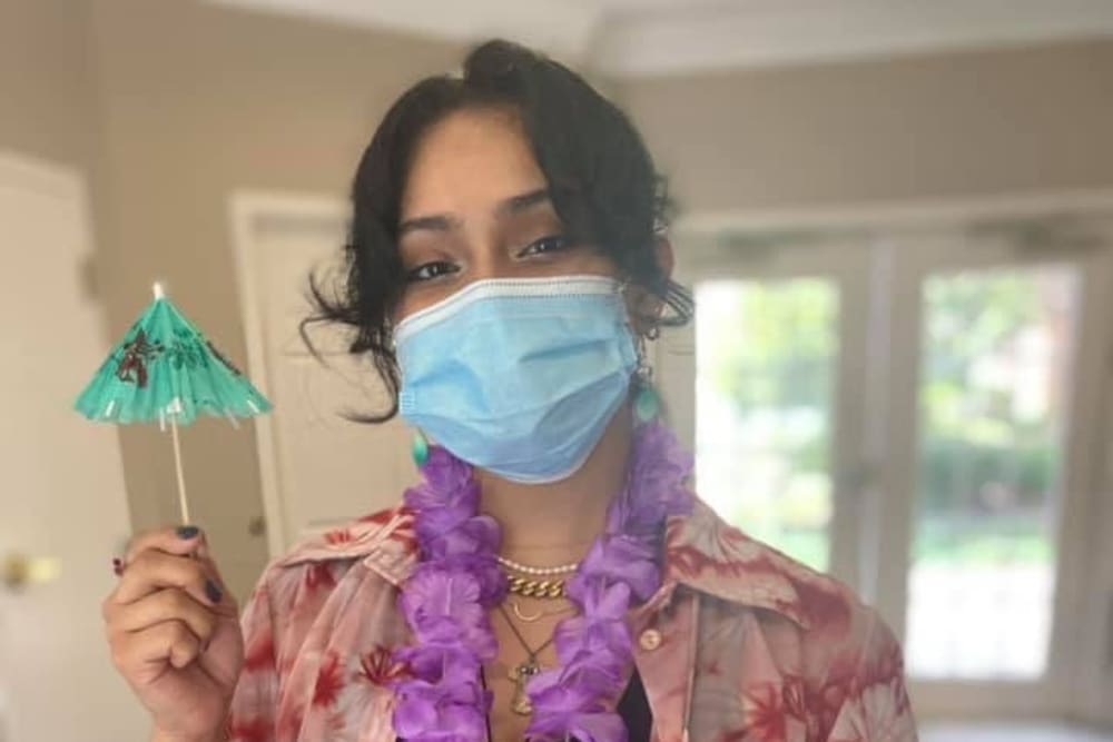 Staff member celebrating with a luau party for residents at Carolina Gardens at Kathwood in Columbia, South Carolina