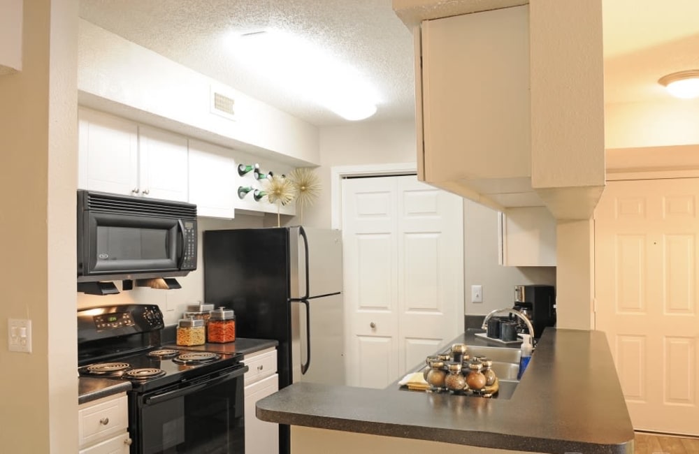 Fully equipped kitchen with a breakfast bar at Hampton Greene Apartment Homes in Columbia, South Carolina