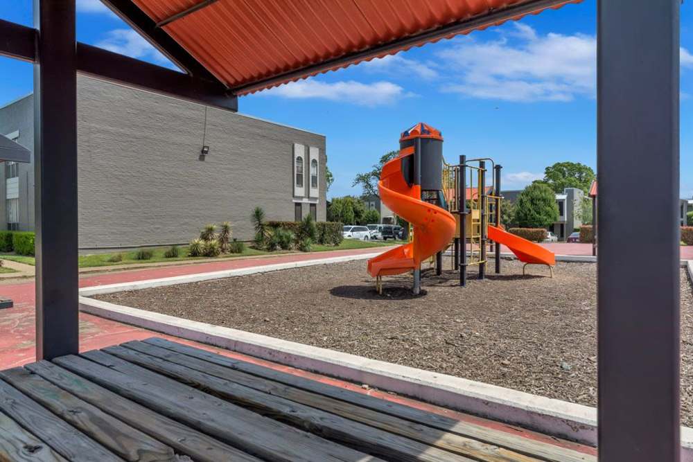 Community playground at Mission Pointe Club Apartments in Euless, Texas
