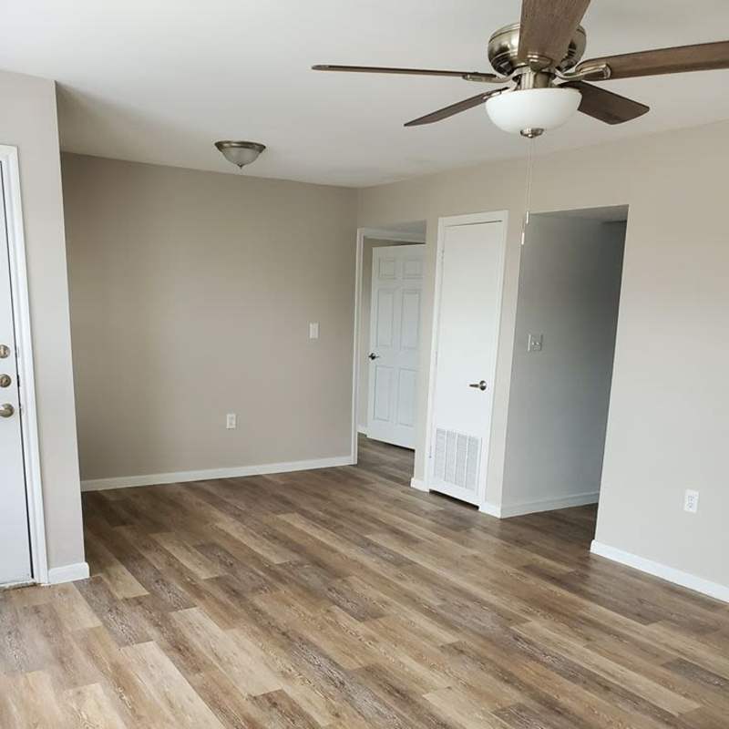 Spacious living room with ceiling fan at Autumn Brook Apartments in Chickasha, Oklahoma