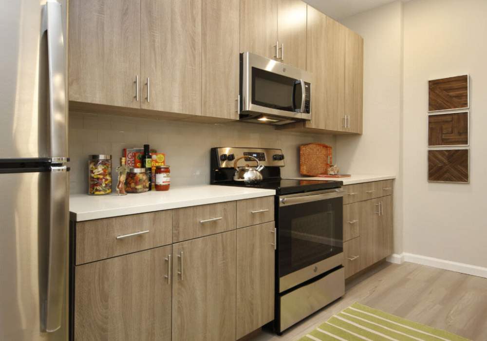 Upgraded kitchen with modern appliances and sleek cabinetry at Messina Luxury Apartments in New Smyrna Beach, Florida