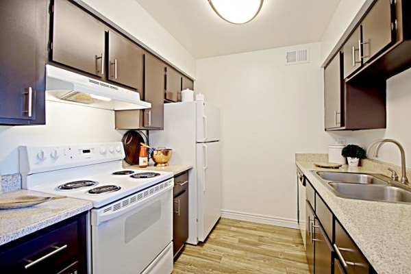 Apartment kitchen with dark cabinetry and trendy appliances at 544 Southern Apartments in Mesa,Arizona