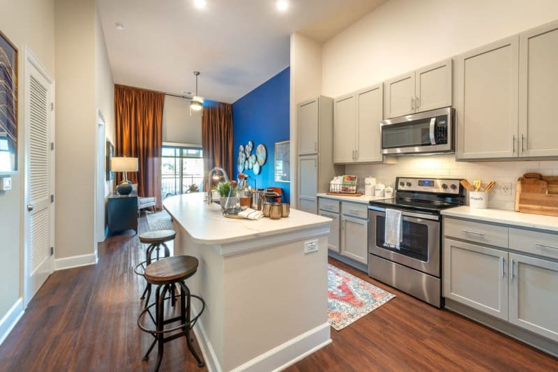 Granite countertops and stainless-steel appliances in a model home's kitchen at Switchyard in Carrollton, Texas