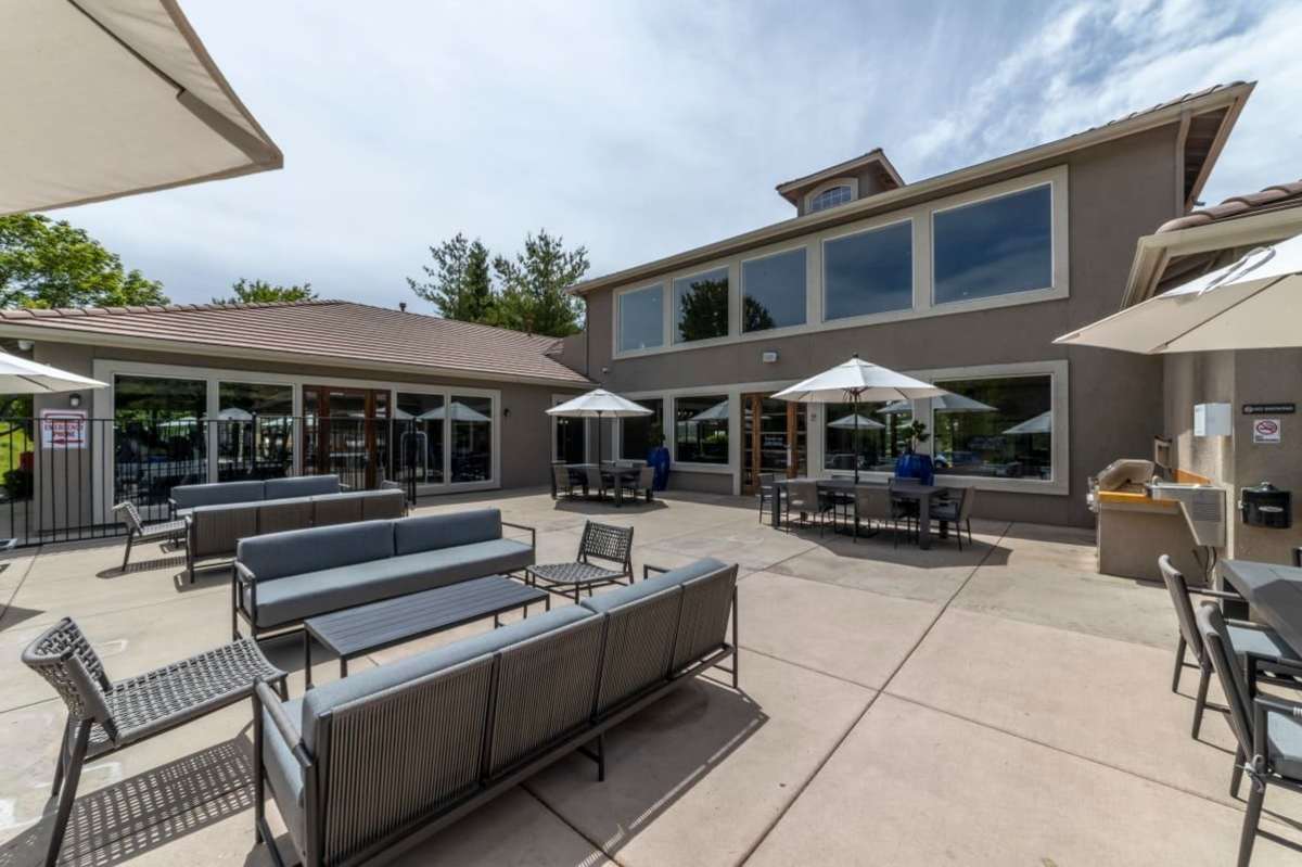 Outdoor seating by the pool at Villas at D'Andrea Apartment Homes in Sparks, Nevada