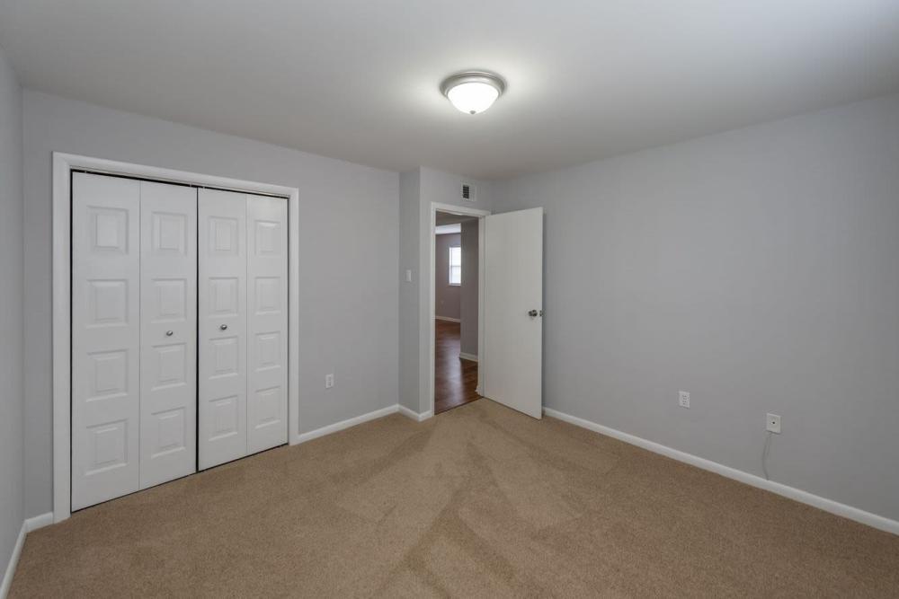 Modern bedroom with walk-in closet at Signal Point Apartments in Mechanicsville, Virginia