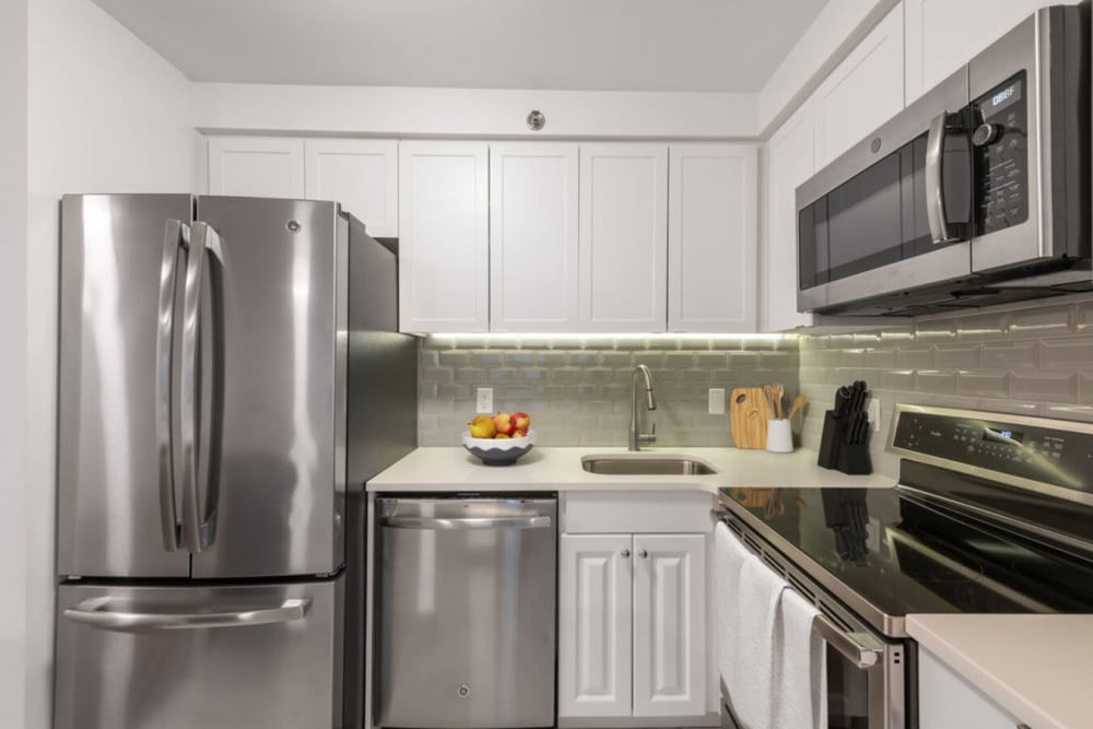 Model kitchen with stainless-steel appliances at 28 Exeter at Newbury in Boston, Massachusetts