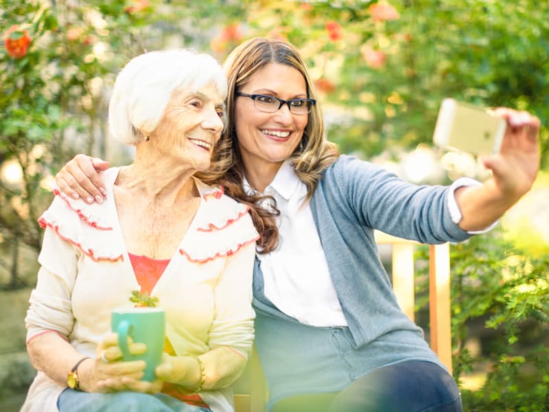 Resident and daughter taking a photo outside of Ingleside Communities in Mount Horeb, Wisconsin