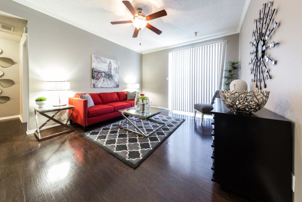 Bright living area with wood style flooring at Marquis at Legacy in Plano, Texas