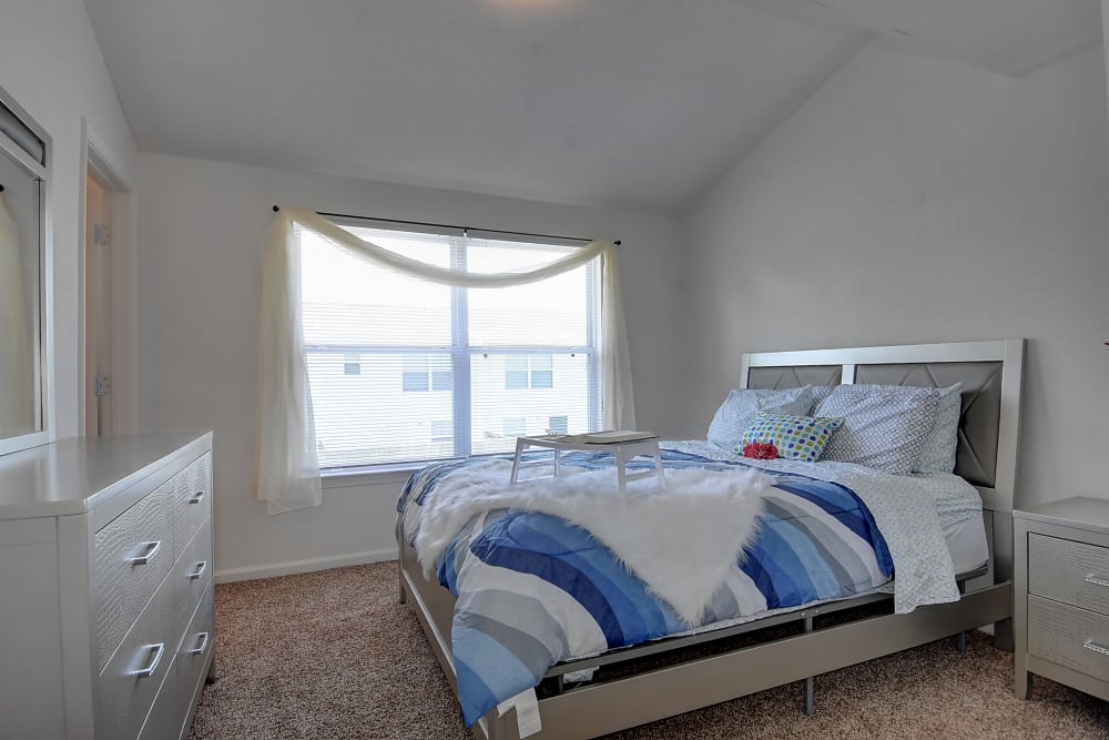 Master bedroom with bed and dresser at Mariner's Watch in Norfolk, Virginia