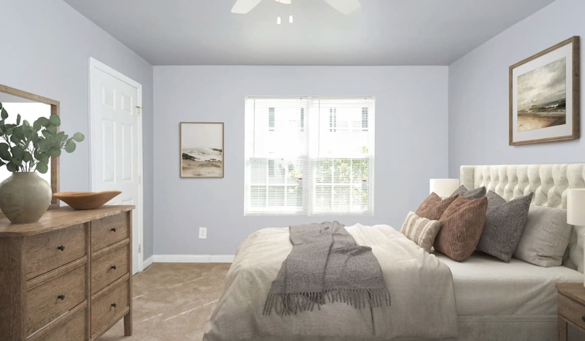 Spacious bedroom with king size bed and large windows at Alston Arms Apartments in North Charleston, South Carolina