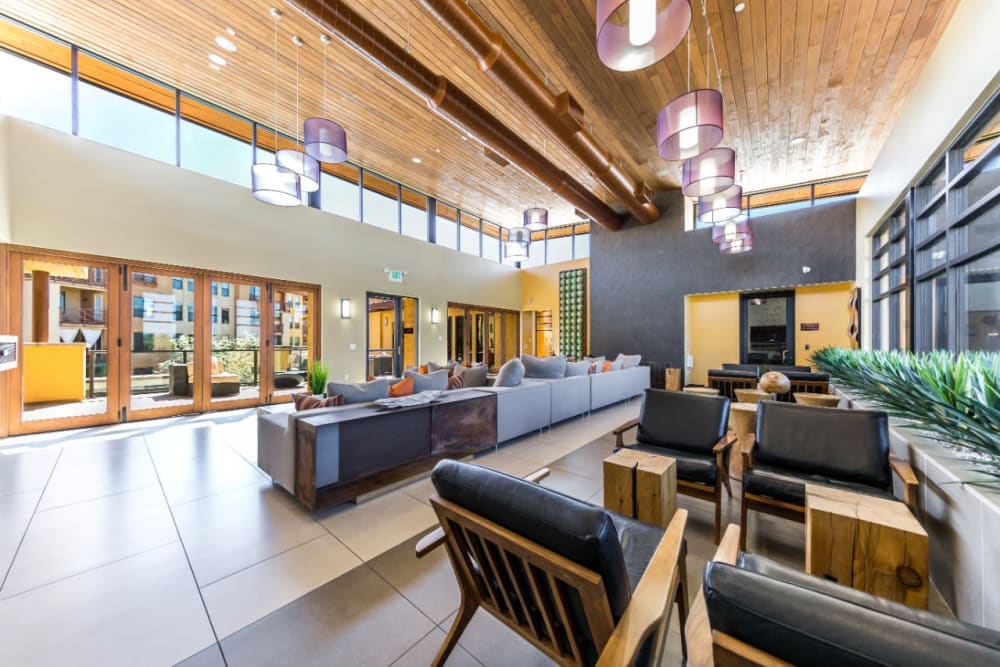Community clubhouse with several sitting couches with many windows at Marquis at Desert Ridge in Phoenix, Arizona