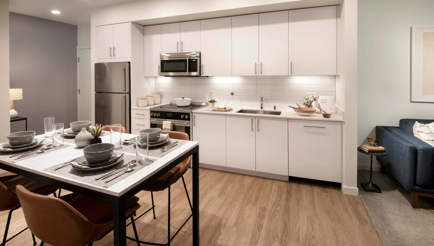 Kitchen with dining table and stainless-steel appliances at Aiya in Gilbert, Arizona