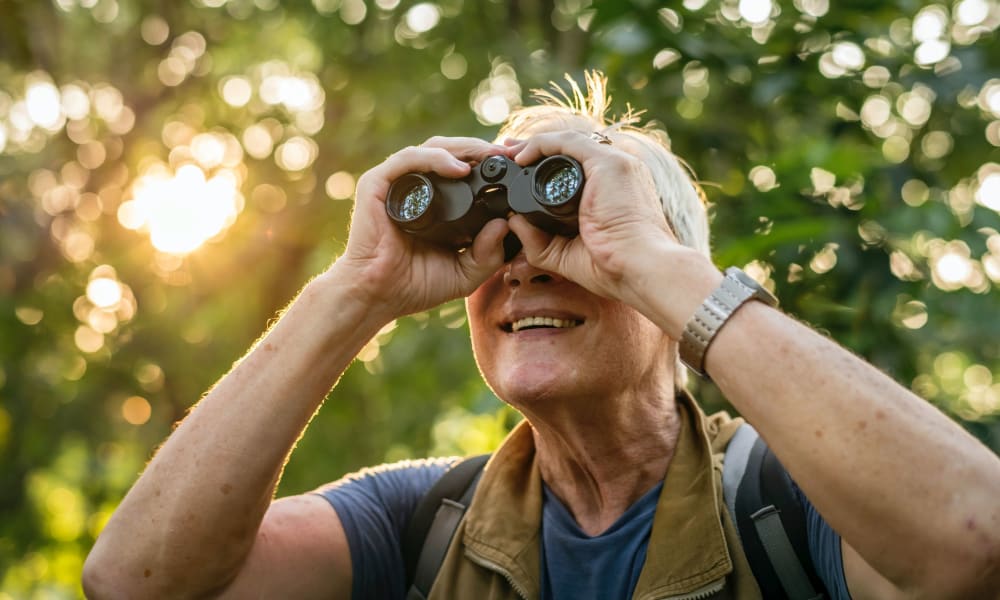A resident outside looking through binoculars at Randall Residence of Fremont in Fremont, Ohio
