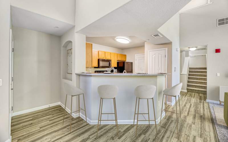 A large kitchen with all the features connecting to living room at The Lofts in Sacramento, California