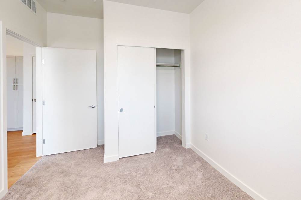 Bedroom with walk-in closet at The Rose on Colfax in Denver,Colorado