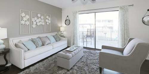 Modern living room with patio access at Derby Park Apartments in Round Rock, Texas, 