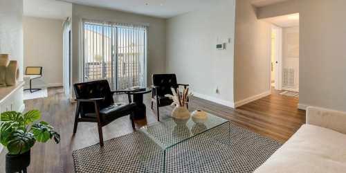 Modern living room with designer coffee table at The Alista Apartments in Dallas, Texas, 